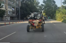 Каруца мина по натоварен булевард с дете, буквално висящо отвън